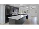 Modern kitchen featuring black cabinets, stainless steel appliances and a large island with stone countertop at 3687 E Leslie Dr, Gilbert, AZ 85296