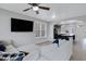 Bright living room with a ceiling fan, hardwood floors, and white sectional sofa at 3687 E Leslie Dr, Gilbert, AZ 85296