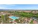 Community pool with palm trees, lounge chairs, and lush green landscaping, offering a resort-like atmosphere at 3687 E Leslie Dr, Gilbert, AZ 85296