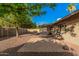Expansive backyard featuring a brick patio, gravel landscaping, and a covered patio with block pillars at 3710 E Mercer Ln, Phoenix, AZ 85028