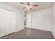 Bedroom features neutral walls, tile floors, ceiling fan and closet, with ample space at 3710 E Mercer Ln, Phoenix, AZ 85028