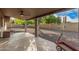 Spacious covered patio with a ceiling fan, concrete floor, and brick pillars overlooking the backyard at 3710 E Mercer Ln, Phoenix, AZ 85028
