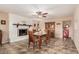Cozy dining room with a white brick fireplace, wooden table set, and rustic decor at 3710 E Mercer Ln, Phoenix, AZ 85028