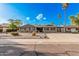 Charming single-story home with desert landscaping, complemented by palm trees and a wide driveway at 3710 E Mercer Ln, Phoenix, AZ 85028