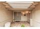 Welcoming front porch featuring tiled flooring, a brick wall, and double doors at 3710 E Mercer Ln, Phoenix, AZ 85028