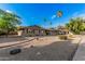 A well maintained front yard features desert landscaping, mature trees, and a charming single-story home at 3710 E Mercer Ln, Phoenix, AZ 85028