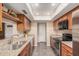 Modern kitchen featuring stainless appliances, granite counters, and wood cabinetry at 3710 E Mercer Ln, Phoenix, AZ 85028