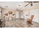 Spacious living room featuring tile floors and multiple ceiling fans for comfort at 3710 E Mercer Ln, Phoenix, AZ 85028