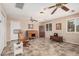 Bright and open living area with ceiling fans, tile floors, and comfortable furniture at 3710 E Mercer Ln, Phoenix, AZ 85028