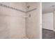 Tiled shower with decorative accents and built-in shelving at 3710 E Mercer Ln, Phoenix, AZ 85028