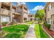 Exterior of apartment complex featuring walkways, staircases, and lush landscaping at 3830 E Lakewood Pkwy # 3099, Phoenix, AZ 85048