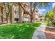 Beautifully maintained condo complex with mature trees and lush green lawn at 3830 E Lakewood Pkwy # 3099, Phoenix, AZ 85048