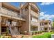 Apartment building featuring tiled roof, balconies, exterior staircases, and well-maintained landscaping at 3830 E Lakewood Pkwy # 3099, Phoenix, AZ 85048