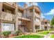 View of an apartment building exterior showing staircases, balconies, and tiled roof at 3830 E Lakewood Pkwy # 3099, Phoenix, AZ 85048