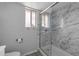 Bathroom with new marble look shower, updated fixtures, tile floors, and a window for natural light at 3973 W Hearn Rd, Phoenix, AZ 85053