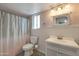 Bathroom with decorative wallpaper, new vanity and lighting, new fixtures, updated toilet, and tile floors at 3973 W Hearn Rd, Phoenix, AZ 85053