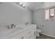 Bathroom with white cabinets, a new marble countertop, double sinks, new fixtures and tile floors at 3973 W Hearn Rd, Phoenix, AZ 85053