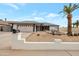 Inviting single-story home showcasing a well-maintained yard with desert landscaping and a tall palm tree at 3973 W Hearn Rd, Phoenix, AZ 85053
