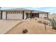 Charming home featuring a two-car garage and desert landscaping with a red front door, creating a welcoming curb appeal at 3973 W Hearn Rd, Phoenix, AZ 85053