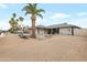Desert landscaped front yard with driveway and palm trees at 3973 W Hearn Rd, Phoenix, AZ 85053