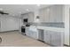 Updated kitchen features stainless steel appliances, stylish cabinetry, and a farmhouse sink with a charming window at 3973 W Hearn Rd, Phoenix, AZ 85053