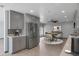 Modern kitchen with stainless steel appliances, gray cabinets, breakfast nook and contemporary light fixtures at 3973 W Hearn Rd, Phoenix, AZ 85053