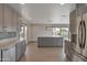 Modern kitchen with gray cabinets, stainless steel appliances, and an island that overlooks a backyard pool at 3973 W Hearn Rd, Phoenix, AZ 85053
