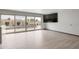 Bright living room featuring sliding glass doors to the backyard pool and modern tile flooring at 3973 W Hearn Rd, Phoenix, AZ 85053