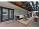 Covered patio with outdoor seating, grill, and string lights, creating a cozy outdoor living space at 3973 W Hearn Rd, Phoenix, AZ 85053