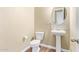 Powder room featuring a pedestal sink and neutral-toned walls with matching tile flooring at 42213 W Santa Fe St, Maricopa, AZ 85138