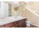 Bathroom featuring a double sink vanity, large mirror, and glass enclosed shower at 42213 W Santa Fe St, Maricopa, AZ 85138