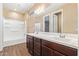 Bright bathroom featuring a double sink vanity and a shower tub combo with white tile at 42213 W Santa Fe St, Maricopa, AZ 85138