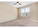 Neutral bedroom featuring a ceiling fan and a window with views of the outside at 42213 W Santa Fe St, Maricopa, AZ 85138