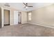 Spacious bedroom with neutral walls and carpet, featuring multiple doorways and ample natural light at 42213 W Santa Fe St, Maricopa, AZ 85138