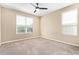 Bright, carpeted bedroom with large windows offering natural light and a comfortable, inviting space at 42213 W Santa Fe St, Maricopa, AZ 85138