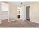 Spacious bedroom showcasing neutral walls and carpet, with doors to the bathroom and closet at 42213 W Santa Fe St, Maricopa, AZ 85138