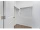 Walk-in closet featuring white walls and shelving, providing ample storage space at 42213 W Santa Fe St, Maricopa, AZ 85138