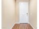 Bright entryway with wood-look tile flooring, light beige walls, and a white front door at 42213 W Santa Fe St, Maricopa, AZ 85138