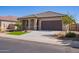 Charming single-story home with desert landscaping, green grass, and a neutral color palette at 42213 W Santa Fe St, Maricopa, AZ 85138
