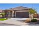 Single-story home with desert landscaping and a well-maintained front yard, complemented by a neutral color scheme at 42213 W Santa Fe St, Maricopa, AZ 85138