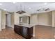 Kitchen island with granite countertops, dark wood cabinets, and a stainless steel sink at 42213 W Santa Fe St, Maricopa, AZ 85138