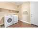 Laundry room featuring a washer, dryer, shelving, and tile flooring at 42213 W Santa Fe St, Maricopa, AZ 85138