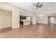 Bright, open-concept living room with an island and a ceiling fan at 42213 W Santa Fe St, Maricopa, AZ 85138