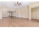 Spacious living room with tile flooring, a ceiling fan, and an open layout at 42213 W Santa Fe St, Maricopa, AZ 85138