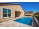 Inviting backyard pool and covered patio area, perfect for outdoor relaxation and entertaining at 42213 W Santa Fe St, Maricopa, AZ 85138
