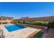 Tranquil pool with a beautiful retaining wall and desert landscaping for enhanced privacy at 42213 W Santa Fe St, Maricopa, AZ 85138