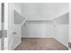 Well-organized walk-in closet with shelving, providing ample storage for your wardrobe and accessories at 42213 W Santa Fe St, Maricopa, AZ 85138