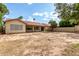 Backyard featuring a stucco house with covered patio, desert landscaping, and a block wall at 510 W Amoroso Dr, Gilbert, AZ 85233