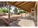 Backyard featuring desert landscaping, covered patio, block wall, and a variety of trees at 510 W Amoroso Dr, Gilbert, AZ 85233
