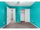 Bedroom featuring light turquoise walls, brown carpet, white doors, and closet with sliding doors at 510 W Amoroso Dr, Gilbert, AZ 85233